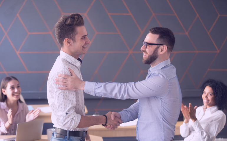 Team lead congratulating an employee.